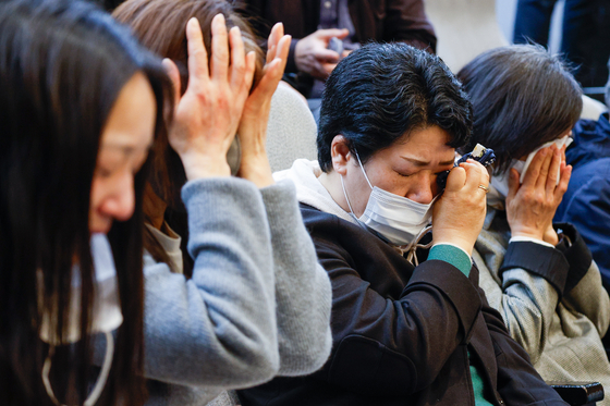 Bereaved families of people who died after receiving Covid-19 vaccinations shed tears after a bill for state compensation passed at the National Assembly in western Seoul on April 2. [NEWS1]