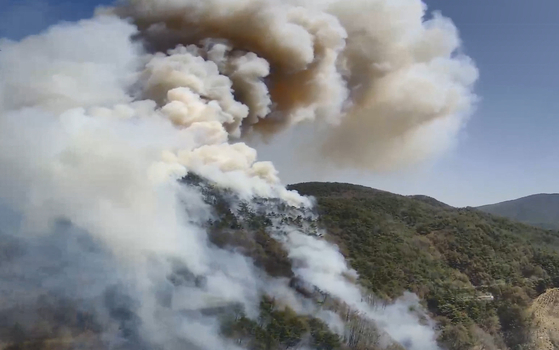 Smoke rises from a wildfire on a hillside in Hadong County, South Gyeongsang, on April 7. [KOREA FOREST SERVICE] 