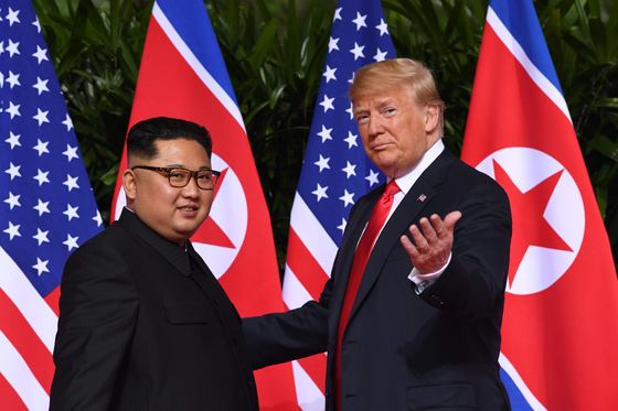 U.S. President Donald Trump, right, gestures as he meets with North Korea's leader Kim Jong-un at the start of their historic U.S.-North Korea summit, at the Capella Hotel on Sentosa island in Singapore on June 12, 2018. [YONHAP]