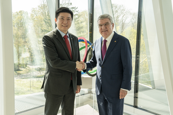 Korean Sport & Olympic Committee President Ryu Seung-min, left, shakes hands with International Olympic Committee (IOC) President Thomas Bach during their meeting at IOC headquarters in Lausanne, Switzerland, on April 8. [NEWS1] 