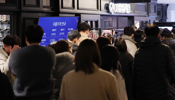 People wait in a long line to have lunch in front of a low-cost buffet restaurant in Seoul on Feb. 12. [NEWS1]