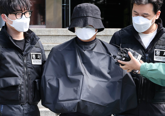 A 56-year-old YouTuber is transferred to the prosecution from Yeonje Police Precinct in Yeonje District, Busan on May 16, 2024. [YONHAP]