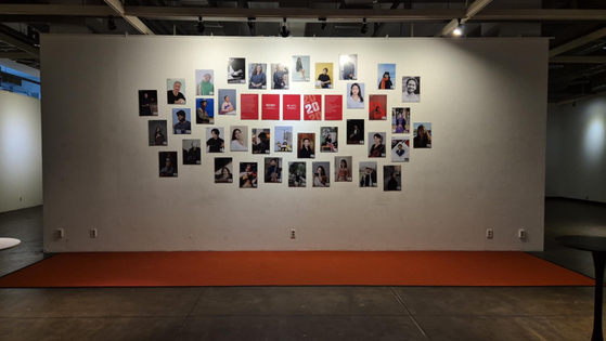 International students at the Korea National University of Arts that were recipients of the AMA+ scholarship hang graduation photographs inside the school in Seongbuk District, central Seoul, on Feb. 5. [KOREA NATIONAL UNIVERSITY OF ARTS]