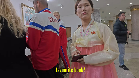 A North Korean guide answer's questions in a video posted on April 14. [SCREEN CAPTURE]