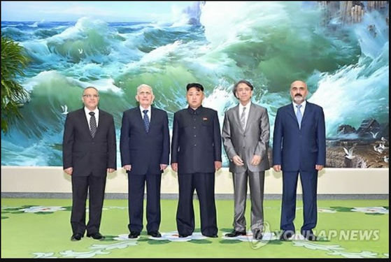 North Korean leader Kim Jong-un, center, poses for a commemorative photo with a Syrian delegation visiting Pyongyang in July 2013 to attend celebrations marking the "Victory Day" armistice anniversary on July 27. [YONHAP]
