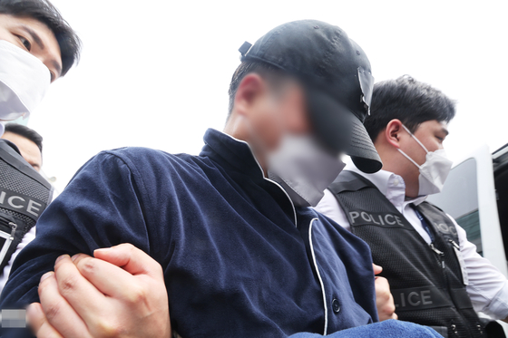 A man in his 50s suspected of murdering his parents, wife and two daughters in Yongin, Gyeonggi, was detained by police on April 17. [YONHAP] 