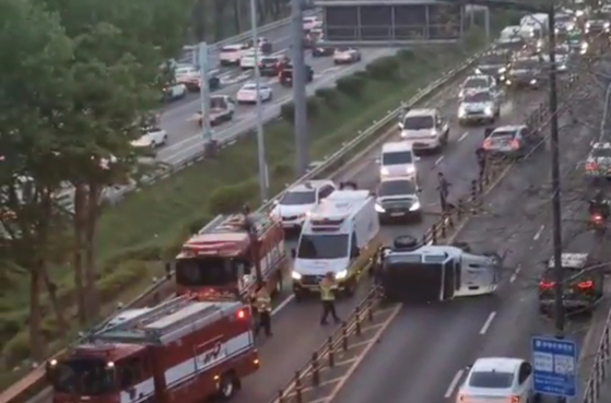 A flipped car lies on the road at the site of the traffic accident on Nodeul-ro,  Dongjak District, southern Seoul, on April 17. [YONHAP] 