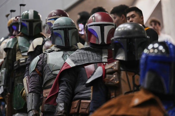 Star Wars fans in different iterations of the Boba Fett costume attend a fan convention called the "Star Wars Celebration" in Chiba, near Tokyo on April 18. [AP]