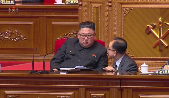 Workers' Party of Korea Organizational Secretary Jo Yong-won, bottom right, bends down and talks to North Korean leader Kim Jong-un during the 8th Party Congress on Jan. 9, 2021. [YONHAP]