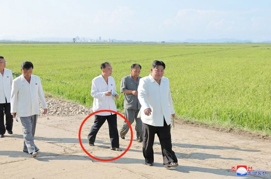 Jo Yong-won, center left, is seen accompanying North Korean leader Kim Jong-un,right, barefoot as Kim provides on-site guidance at Ogyeri and Wollang farms in Anbyon County, which were damaged by typhoons in 2023. [YONHAP]