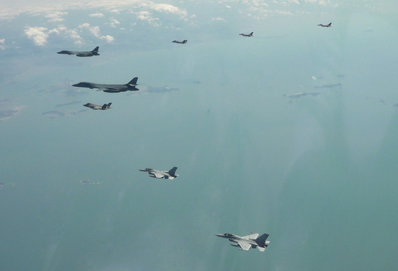 Two U.S. Air Force B-1B bombers, top left, fly over the Korean Peninsula with Korean Air Force F-35A fighter jet, F-16 fighter jets and U.S. Air Force F-16 fighter jets in Korea during U.S.-Korea joint aerial drills on April 15. [AP/YONHAP]