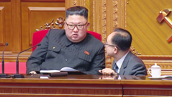 Jo Yong-won, right, kneels and reports to Kim Jong-un in an image captured on Korean Central Television on Jan. 9, 2021. [YONHAP]