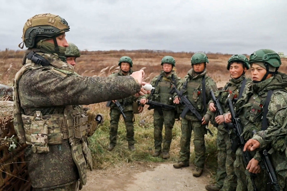 This photo from Russia's Tass News Agency shows a firearms training session with Russian instructors for servicemen from North Korea who were involved in Russia's operation to liberate the Kursk Region [YONHAP]