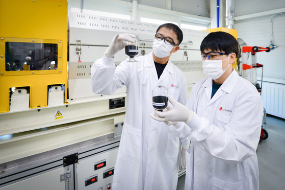 Researchers are seen handling material at a LG Energy Solution laboratory [LG ENERGY SOLUTION] 