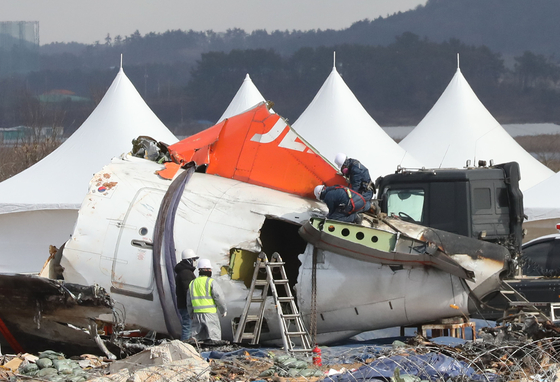 Workers are seen at the wreckage of a Jeju Air passenger aircraft that crashed at Muan International Airport on Dec. 29, 2024 on Jan. 15. [NEWS1]