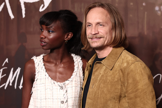 French-Cape Verdean model and actor Alice Da Luz, left, and Belgian actor Jérémie Renier pose upon arrival for a screening of Apple TV's new French series ″Careme″ at the Hotel Meurice in Paris on April 2. [AFP/YONHAP]