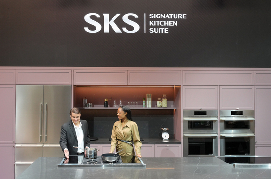 Participants at the Design and Construction Week 2025 try out the premium built-in appliances of SKS, owned by LG Electronics, at a venue in Las Vegas on Feb. 25. [LG ELECTRONICS] 