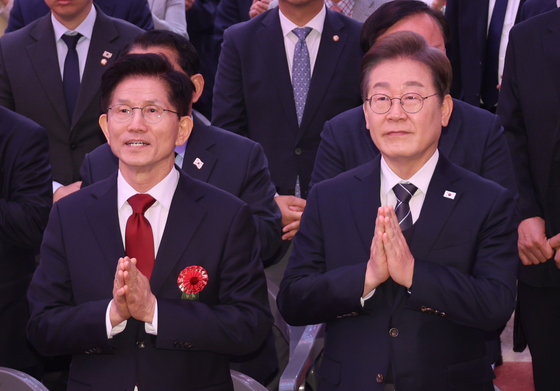 Democratic Party's presidential candidate Lee Jae-myung, left, and People Power Party candidate Kim Moon-soo attend a celebratory Buddhist ceremony in front of the Daeungjeon Hall at Jogye Temple in Jongno District, central Seoul, on May 5, Buddha’s Birthday in the year 2569 of the Buddhist calendar. [JOINT PRESS CORPS]