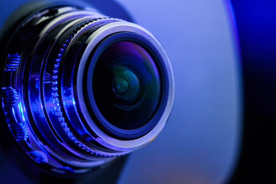 Illustration of camera lens with blue light [GETTY IMAGES BANK]