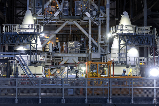 The Twin SLS (Space Launch System) solid rocket boosters, that will be used in the Artemis II mission, are being assembled inside the Vehicle Assembly Building at the Kennedy Space Center in Titusville, Florida, on March 7. According to NASA, Artemis II will send a crew of four astronauts on a journey around the Moon and bring them back safely, paving the way for future long-term human exploration missions to the lunar surface and eventually Mars. [EPA/YONHAP]