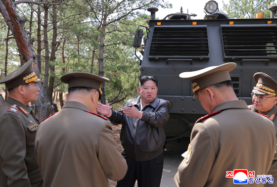 North Korean leader Kim Jong-un, center, speaks to military leaders as he oversees a joint strike drill involving long-range artillery and a new variant of tactical ballistic missiles on the eastern front on May 8, 2025, in this photo released by the North's official Korean Central News Agency on May 9. In the drill, involving a multilayer rocket system and the Hwasongpho-11-Ka tactical ballistic missile, Kim emphasized the combat readiness of the country's nuclear forces, the report said. [YONHAP]