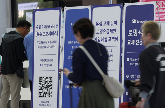 Customers wait to get their SIM cards replaced at an SK Telecom store inside the Gimpo International Airport on May 9. [NEWS1]