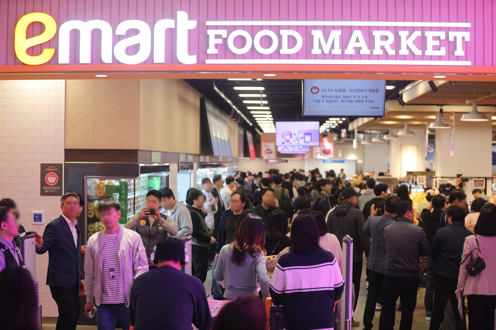 Shoppers enter Emart Food Market's Godeok branch in Gangdong District, eastern Seoul, on its opening day on April 17. [NEWS1] 