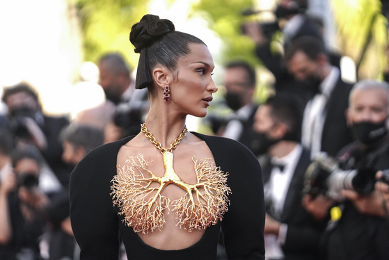 Bella Hadid poses for photographers at the premiere of ″Three Floors″ at the 74th Cannes Film Festival, Cannes, southern France on July 11, 2021. [AP/YONHAP]