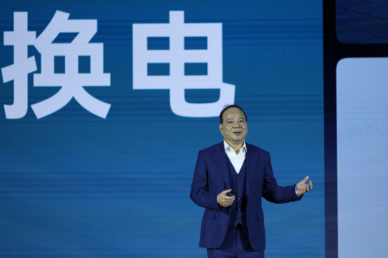 Robin Zeng, the CEO of China-based CATL battery manufacturing company, speaks near the words reads ″swap battery″ at a launch event for the next generation of swap stations in Xiamen, Fujian province, China, on Dec. 18, 2024. [AP/YONHAP]