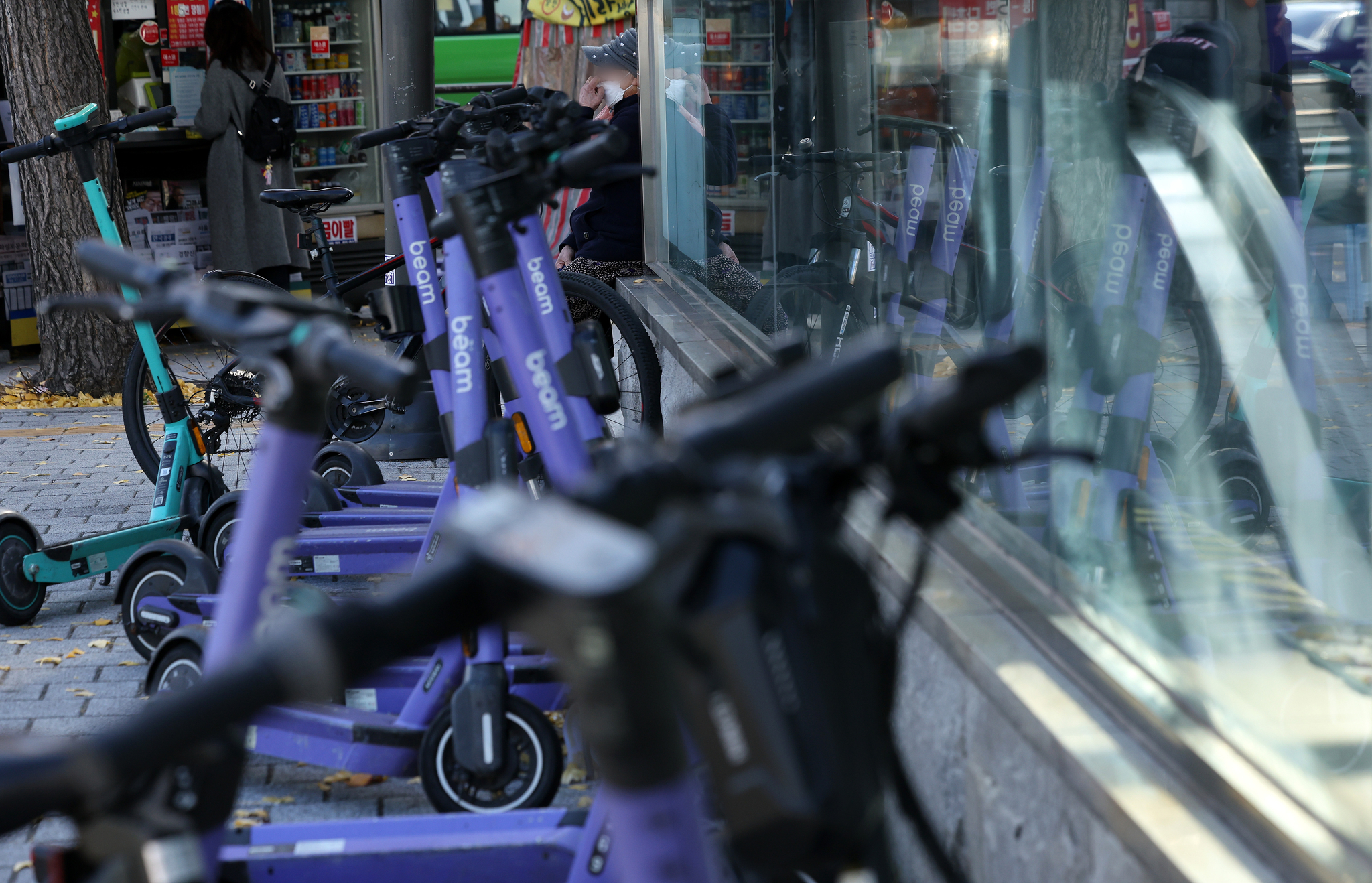 Electric scooters are parked near a train station in downtown Seoul on Nov. 19, 2024. [NEWS1]