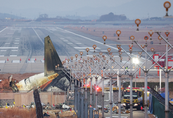 The wreckage of the Jeju Air aircraft that went off the runway and crashed lies at Muan International Airport, in Muan, Korea, Dec. 30, 2024. [REUTERS/YONHAP]