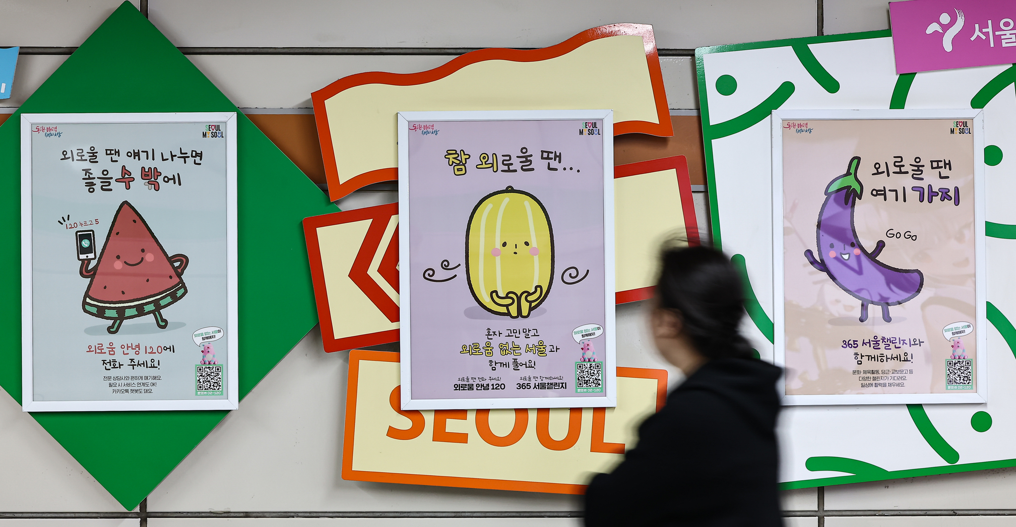 A citizen walks by posters promoting the “Goodbye Loneliness Helpline 120” service from the Seoul Metropolitan Government at Sindang Station in Jung District, central Seoul on April 1. [NEWS1]