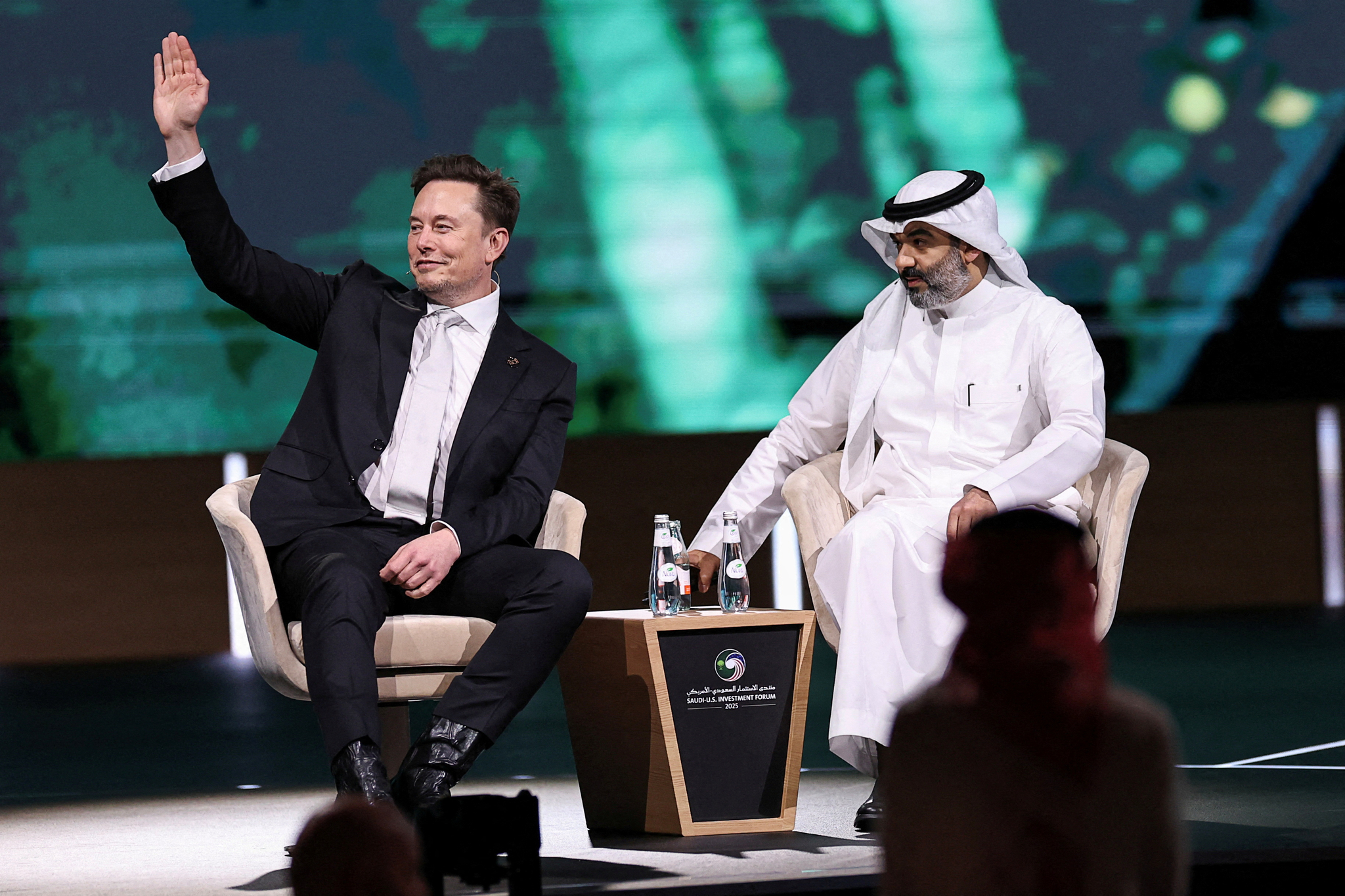 Tesla CEO Elon Musk, left, sits with Saudi Minister of Communications and Information Technology Abdullah Alswaha at the Saudi-U.S. Investment Forum, in Riyadh, Saudi Arabia, on May 13. [REUTERS/YONHAP]