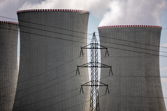Pylons carry high voltage electricity cables past cooling towers operating at the Dukovany nuclear power plant operated by CEZ AS, near the village of Dukovany, Czech Republic, on May 12. [EPA/YONHAP]
