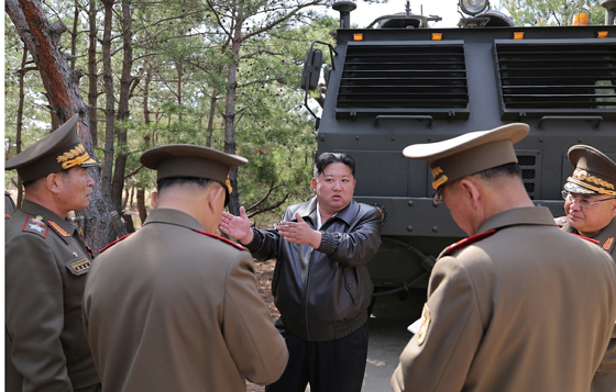 North Korean leader Kim Jong-un supervises a combined strike drill involving long-range artillery and missile systems on May 8. [YONHAP]