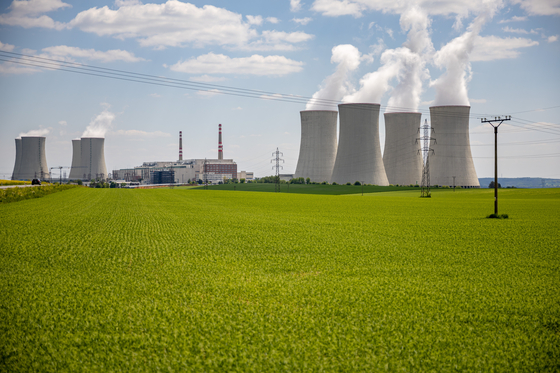 Pylons carry high voltage electricity cables across a field past cooling towers operating at the Dukovany nuclear power plant operated by CEZ AS, near the village of Dukovany, Czech Republic, on May 12. [EPA/YONHAP]