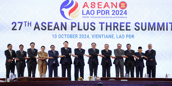 Leaders of Asean nations pose for a commemorative photo during the Asean plus three summit at a hotel in Vientiane, Laos, on Oct. 10, 2024. [JOINT PRESS CORPS]