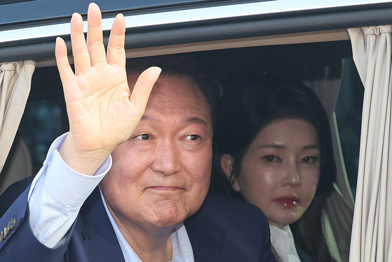 Former President Yoon Suk Yeol and his wife, Kim Keon Hee, greet supporters as they leave the presidential residence in Hannam-dong, Yongsan District, central Seoul, and head to their private home in Seocho-dong on April 11, 2025. [JOINT PRESS CORPS]