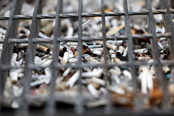 Cigarette butts pile up in a gutter near Gangnam Station in southern Seoul on June 23, 2023. [YONHAP]