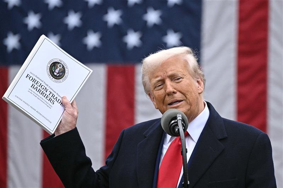  U.S. President Donald Trump holds the 2025 National Trade Estimate Report on Foreign Trade Barriers by the Office of the United States Trade Representative during an event to announce new tariffs at the White House in Washington on April 2.