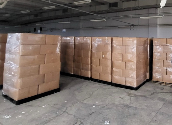 Some 500,000 expired face masks are stacked at a factory in Ulsan. Upcycling company Touch4Good received the masks from a distributor earlier this year to develop recycling methods. [TOUCH4GOOD]