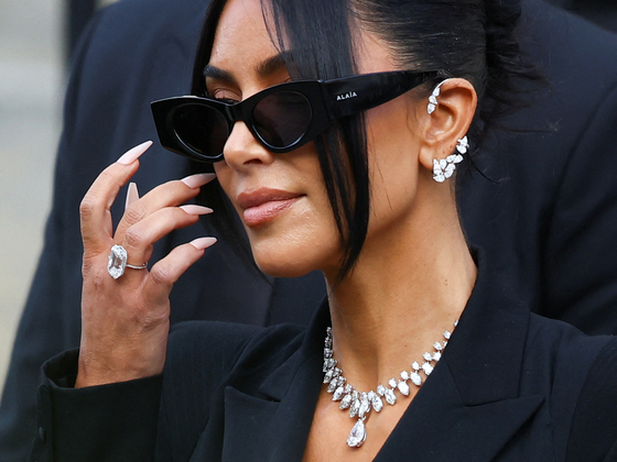 Kim Kardashian leaves the courthouse after testifying in the trial of 10 people accused of stealing millions of dollars worth of jewellery from her, who was held at gunpoint in her apartment during Paris fashion week in 2016, a trial known as the ″Rue Tronchet″ affair, in Paris on May 13. [REUTERS/YONHAP]