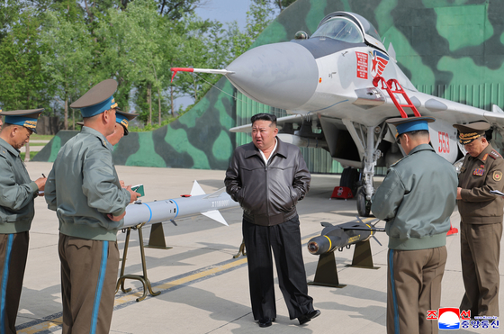 Kim Jong-un, in leather jacket, visits a flight group under the Guards 1st Air Division of the Korean People's Army on May 15, [YONHAP]
