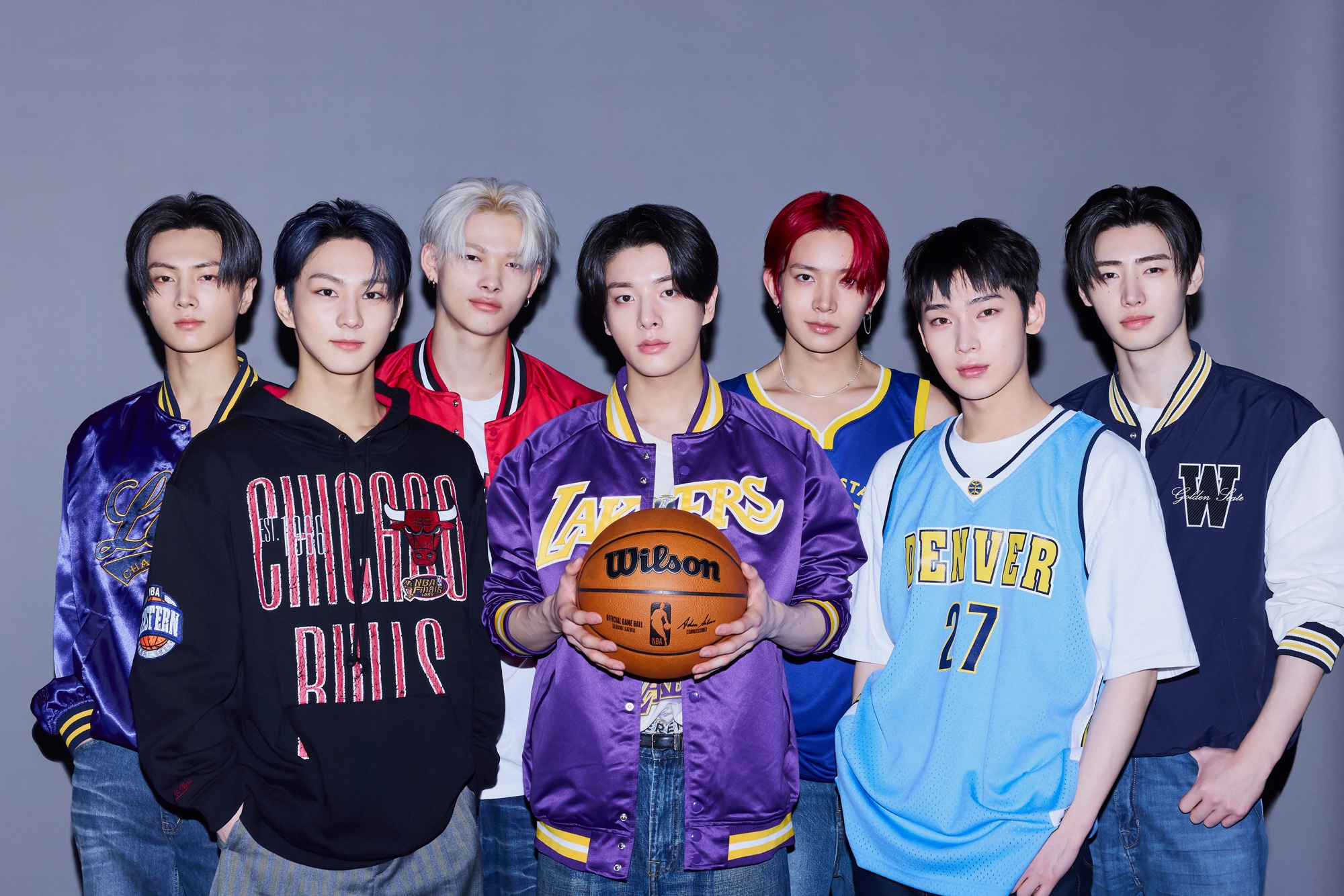 Enhypen members pose for a photo with merchandise from NBA teams [NBA]