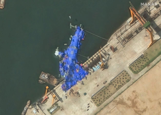 A handout satellite image made available by Maxar Technologies shows a new North Korean warship at the harbour after its launch accident in Chongjin, North Korea on May 23. [EPA/YONHAP] 