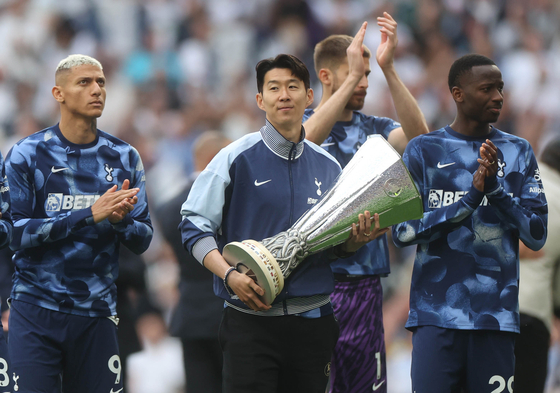 Son Heung-min of Tottenham holds the UEFA Europa League winners trophy during a lap of honour after the English Premier League match between Tottenham Hotspur and Brighton in London on May 25. [EPA/YONHAP]