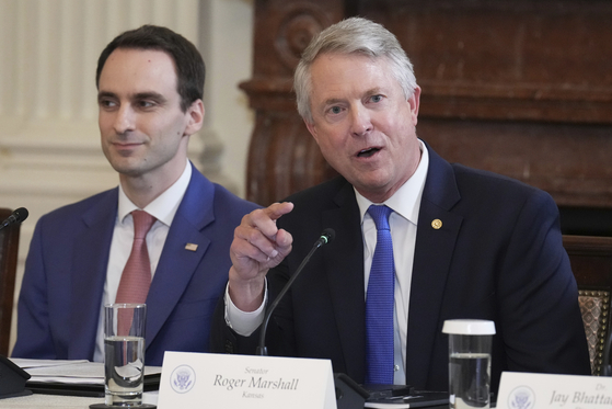 Sen. Roger Marshall speaks as Michael Kratsios, White House director of the Office of Science and Technology Policy, listens during a Make America Healthy Again Commission event in the East Room of the White House on May 22 in Washington. [AP/YONHAP]
