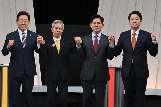 The four candidates pose for a photo ahead of the debate on May 27. [YONHAP]