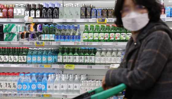 Bottles of soju are displayed at a supermarket in Seoul on Feb. 26, 2023. [YONHAP] 