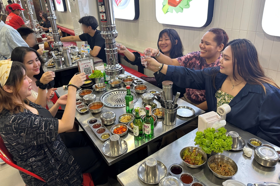 Filipino consumers enjoy Korean food while drinking Jinro soju in Manila on May 19. [HITEJINRO]